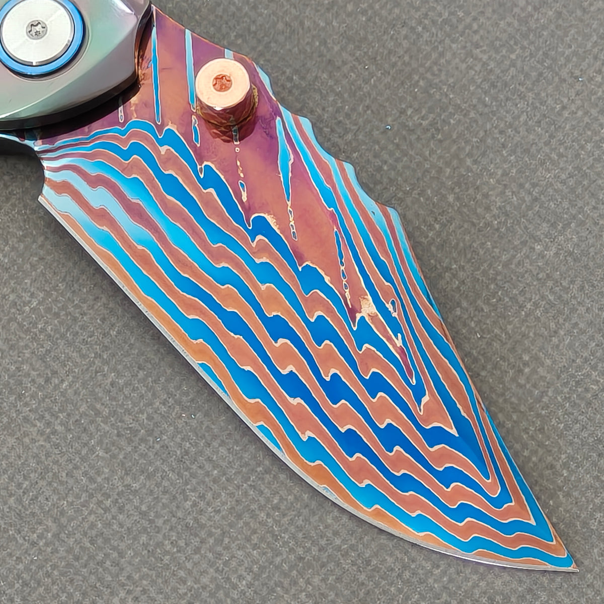 VORIXN Steelwraith KB143 Folding Knife – clip side blade detail showing Damascus steel and Zirconium handle junction.