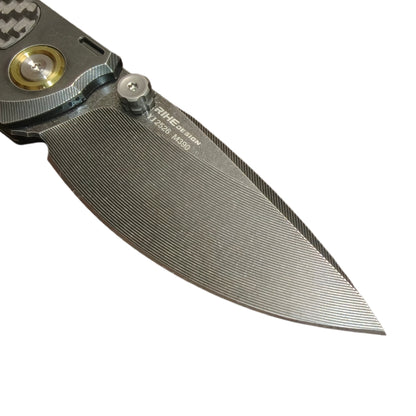 9. VORIXN KB077 blade close-up showing CNC milled texture and black PVD coating on Bohler M390 steel