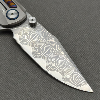 VORIXN KB019 clip-side blade detail showing the Damascus blade pattern.