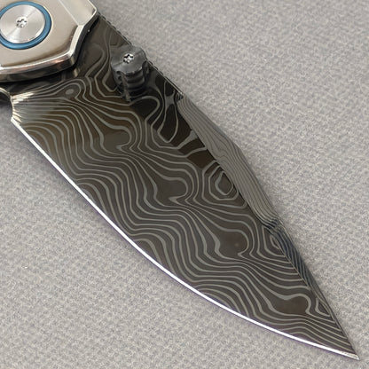 VORIXN Ocean Mirage KB104 Folding Knife – clip side blade detail showing Damascus DLC-Coated steel and handle junction