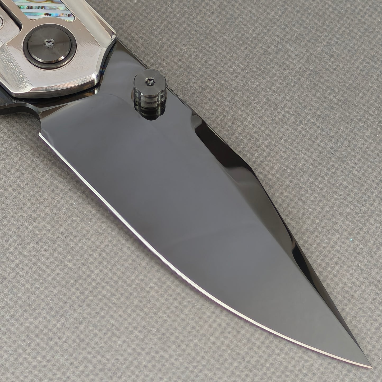 VORIXN KB103 Ocean Mirage Folding Knife – clip side blade detail showing M390 steel and Mother-of-Pearl handle junction