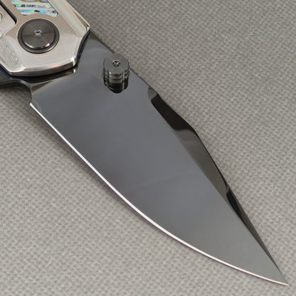 VORIXN KB103 Ocean Mirage Folding Knife – clip side blade detail showing M390 steel and Mother-of-Pearl handle junction