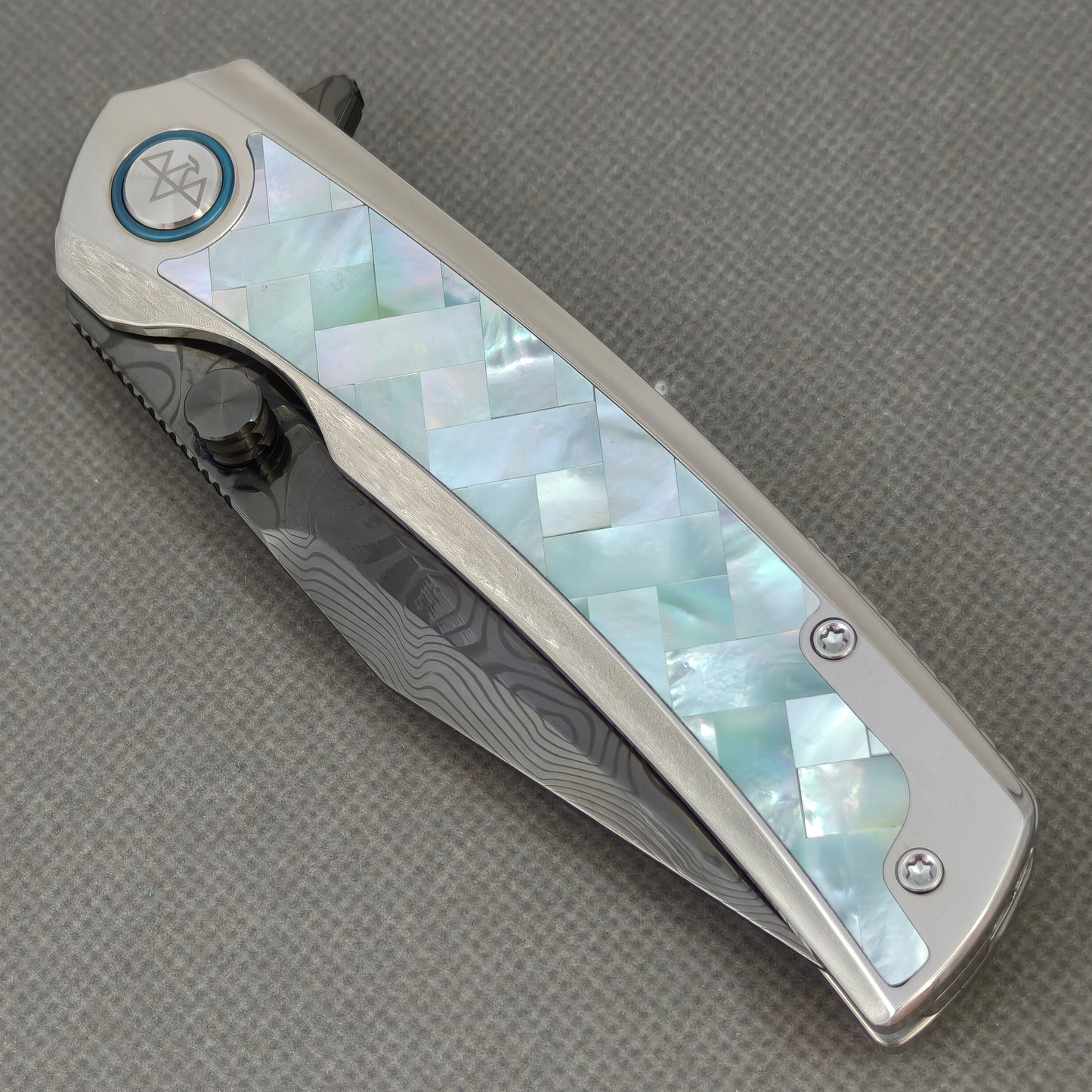 VORIXN KB104 Ocean Mirage Folding Knife – closed non-clip side view showing Mother-of-Pearl Inlaid Titanium handle design and pivot
