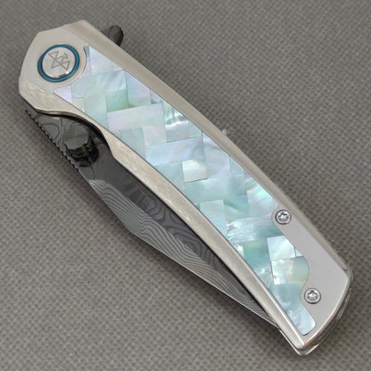 VORIXN KB104 Ocean Mirage Folding Knife – closed non-clip side view showing Mother-of-Pearl Inlaid Titanium handle design and pivot