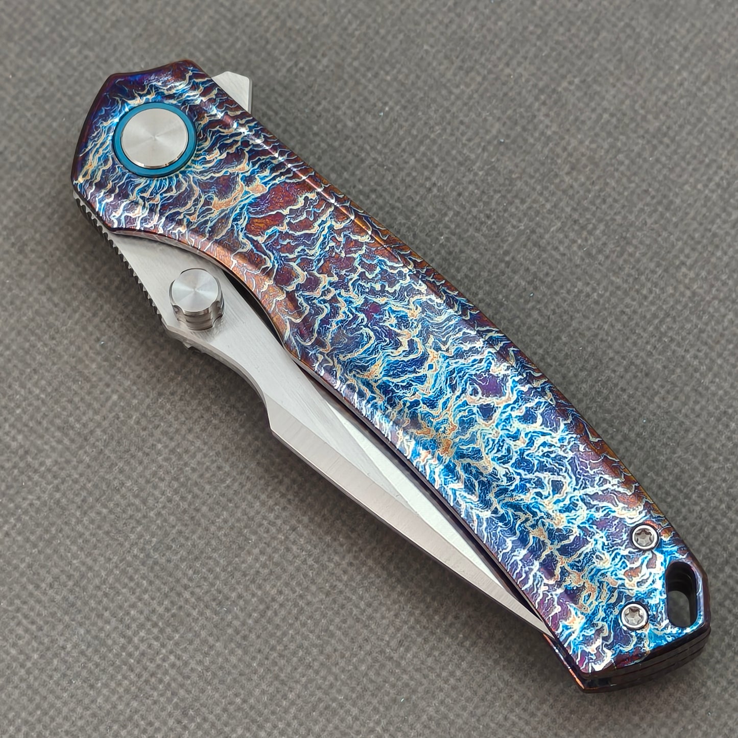 VORIXN KB051 closed non-clip side view showing hand-flamed titanium handle design and pivot detail.