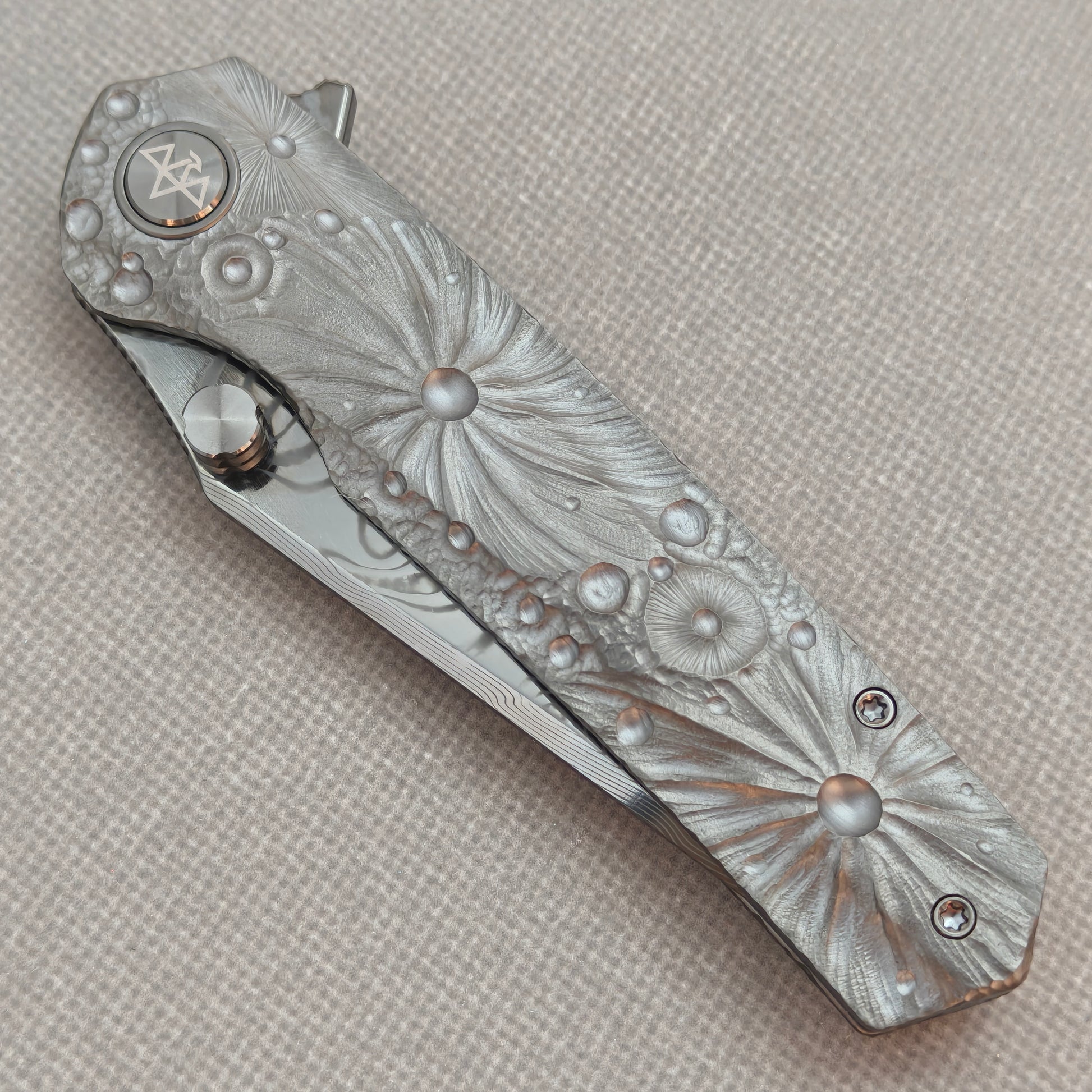 VORIXN KB098 Impact Origin Folding Knife – closed non-clip side view showing engraved Titanium handle design and pivot