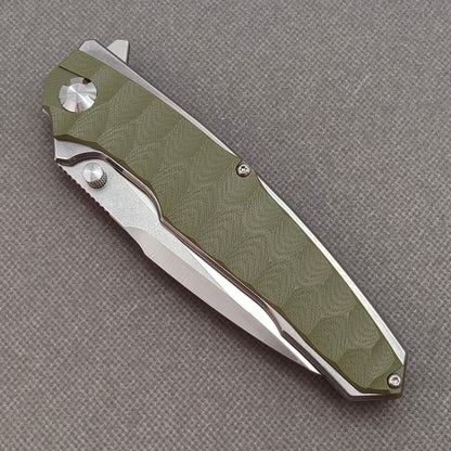 VORIXN KA007 closed non-clip side view showing green G10 handle design and pivot detail.
