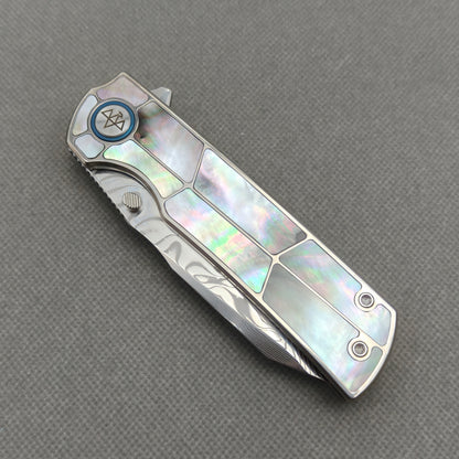 VORIXN KB059 closed non-clip side view showing black pearl inlaid titanium handle design and pivot detail.