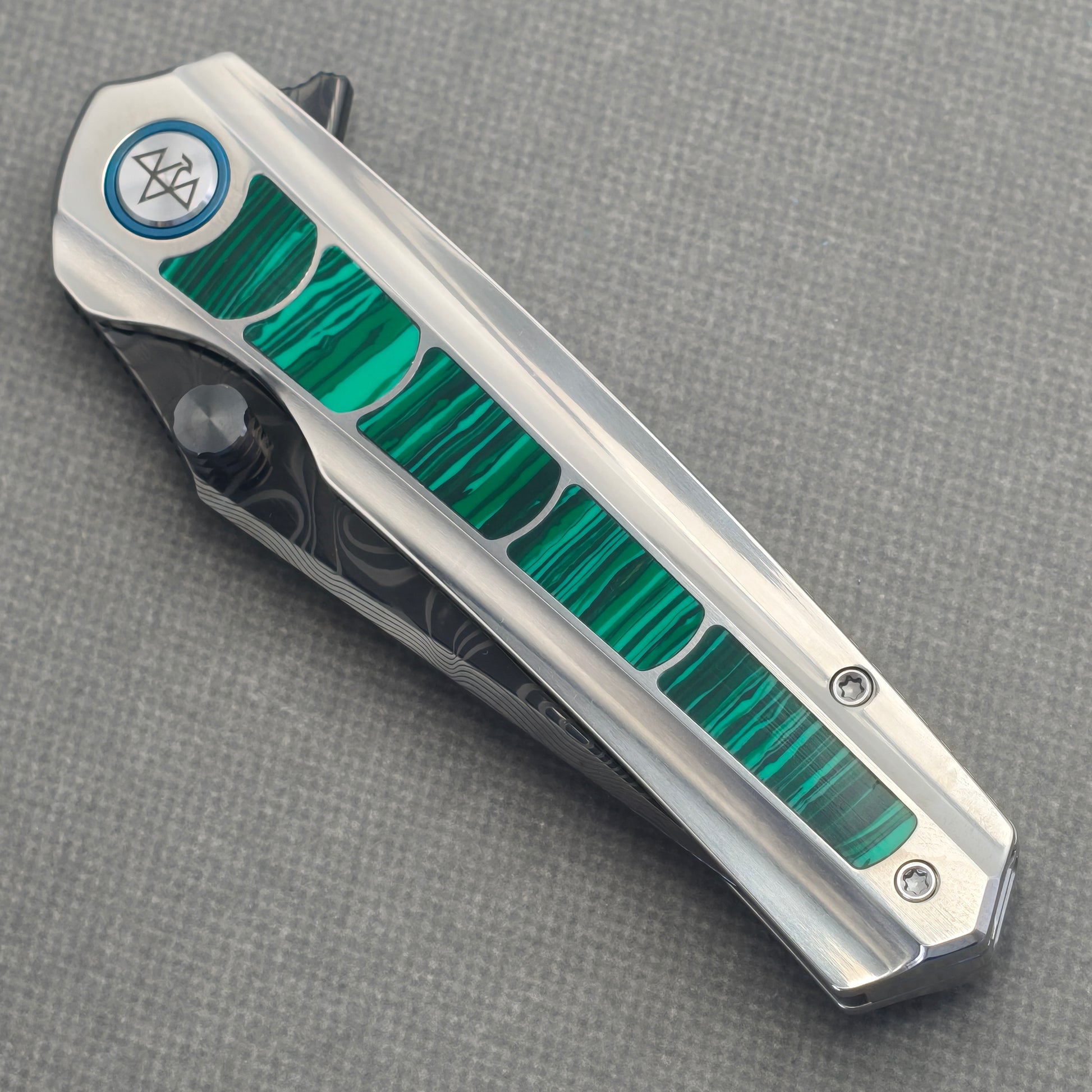 VORIXN Forest Mirage KB131 Folding Knife – closed non-clip side view showing malachite inlaid titanium handle design and pivot