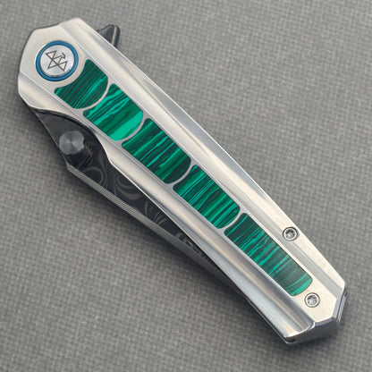 VORIXN Forest Mirage KB131 Folding Knife – closed non-clip side view showing malachite inlaid titanium handle design and pivot