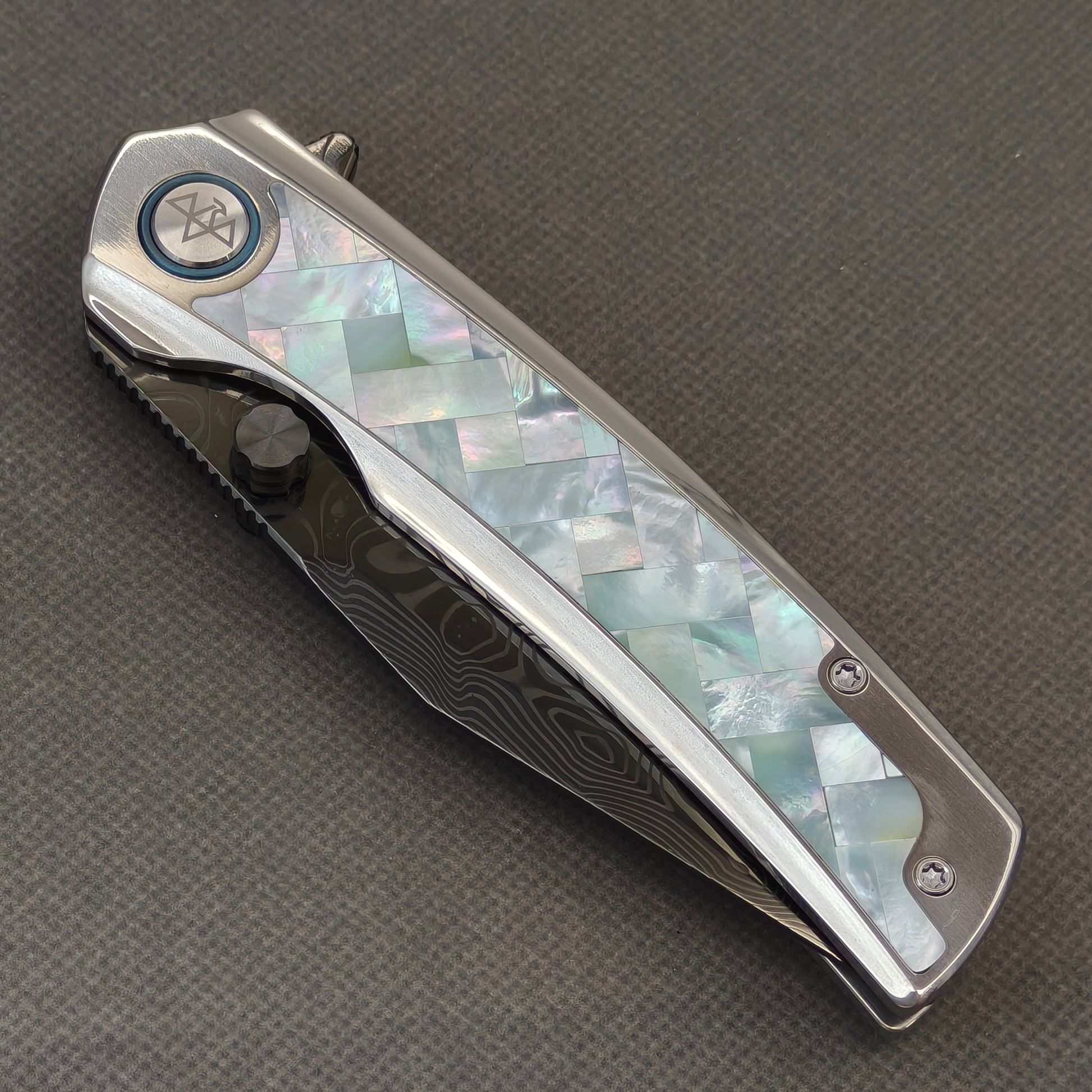 VORIXN Ocean Mirage KB104 Folding Knife – closed non-clip side view showing White Mother-of-Pearl Inlaid Titanium handle design and pivot