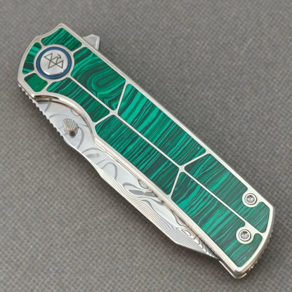 VORIXN KB062 closed non-clip side view showing malachite inlaid titanium handle design and pivot detail.