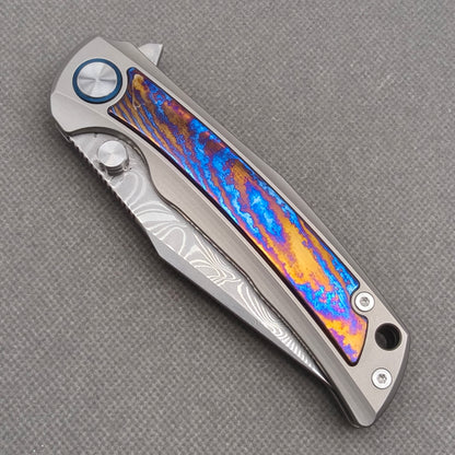 VORIXN KB019 closed non-clip side view showing titanium and zirconium inlay handle design and pivot detail.
