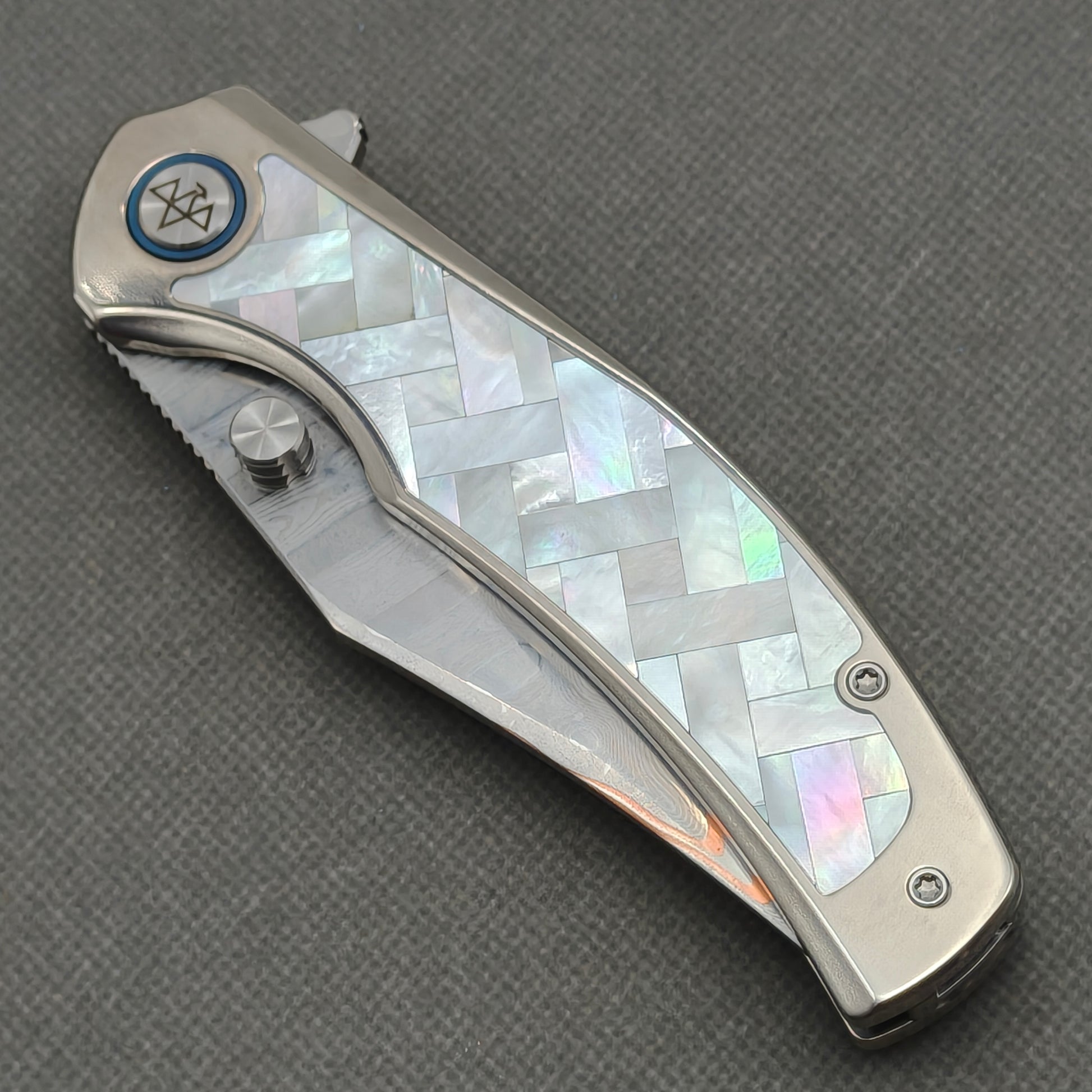 VORIXN KB068 closed non-clip side view showing white pearl inlaid titanium handle design and pivot detail.