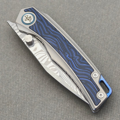 VORIXN Tidecipher KB157 Folding Knife – closed non-clip side view showing blue wave-pattern inlay and branded pivot.