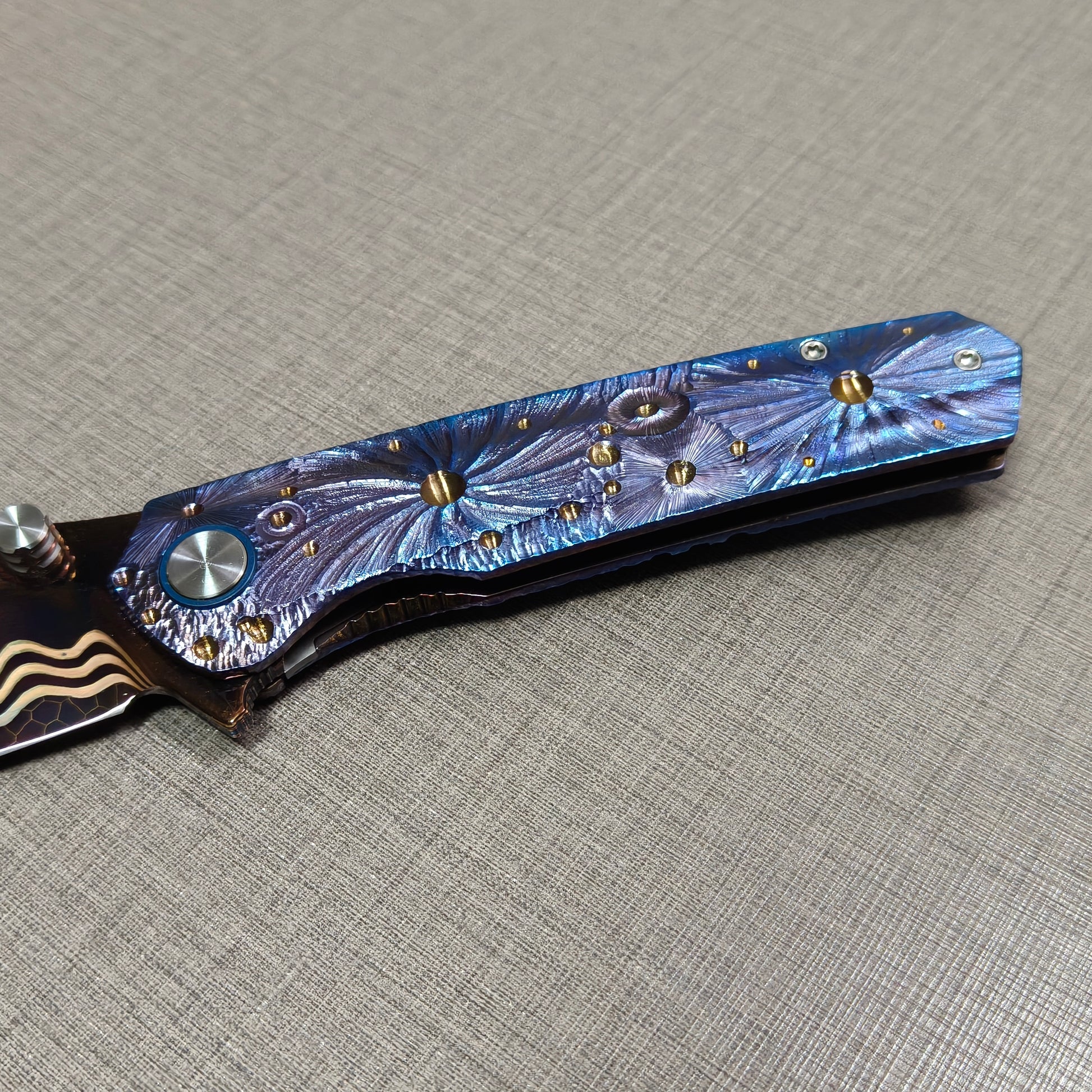 VORIXN Impact Origin folding knife  non-clip side showing full engraved titanium handle inspired by meteor impacts
