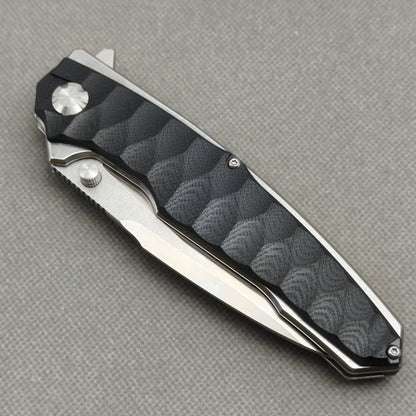 VORIXN KA009 closed non-clip side view showing black G10 handle design and pivot detail.