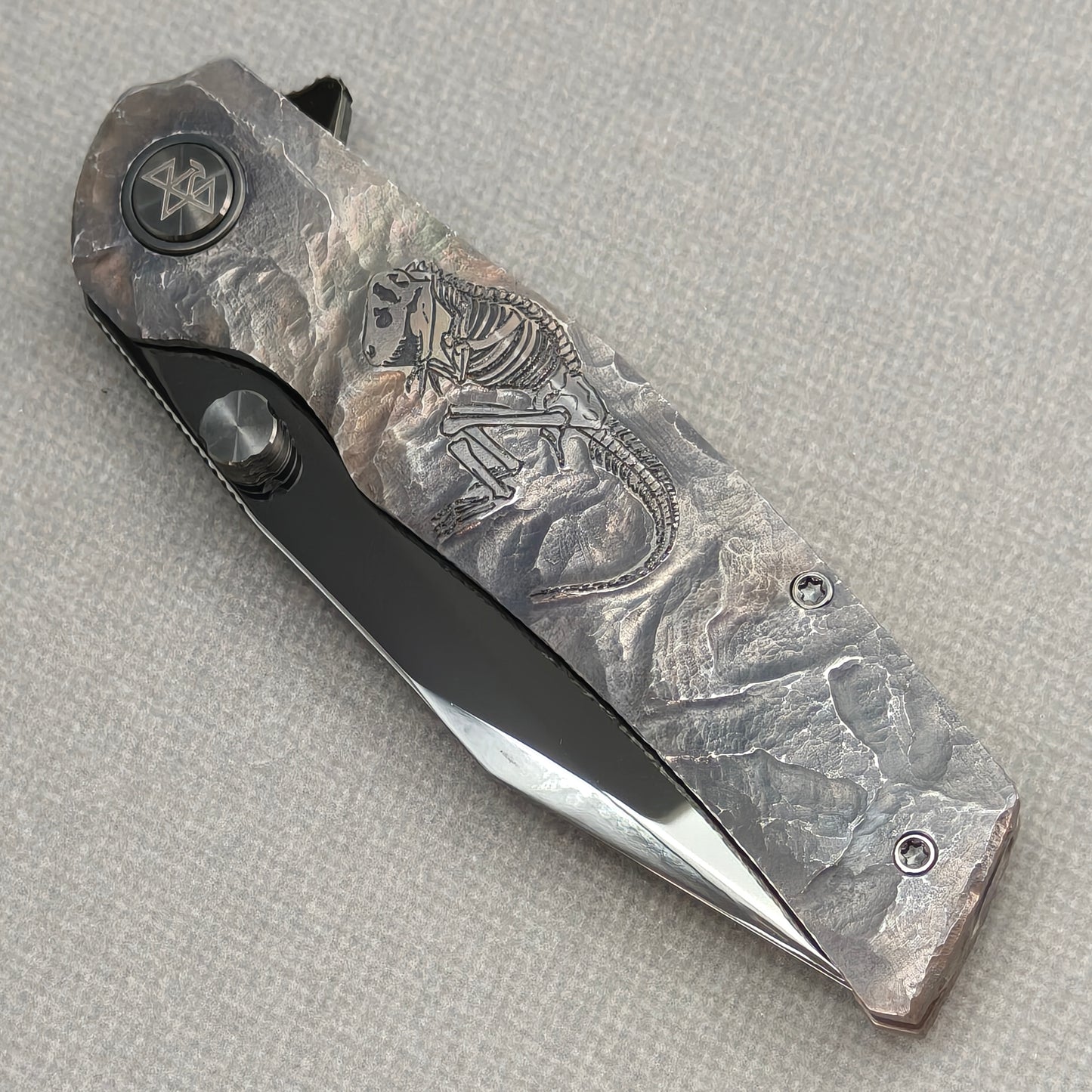 VORIXN Rex KB119 Folding Knife – closed non-clip side view showing hand-engraved titanium handle design and pivot