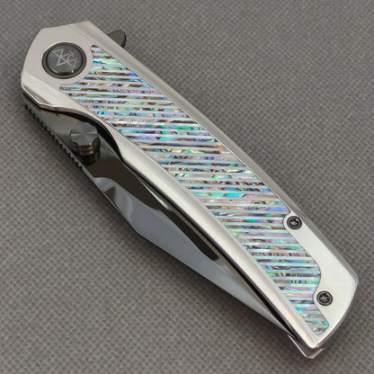 VORIXN KB103 Ocean Mirage Folding Knife – closed non-clip side view showing Iridescent Mother-of-Pearl Inlaid Titanium handle design and pivot