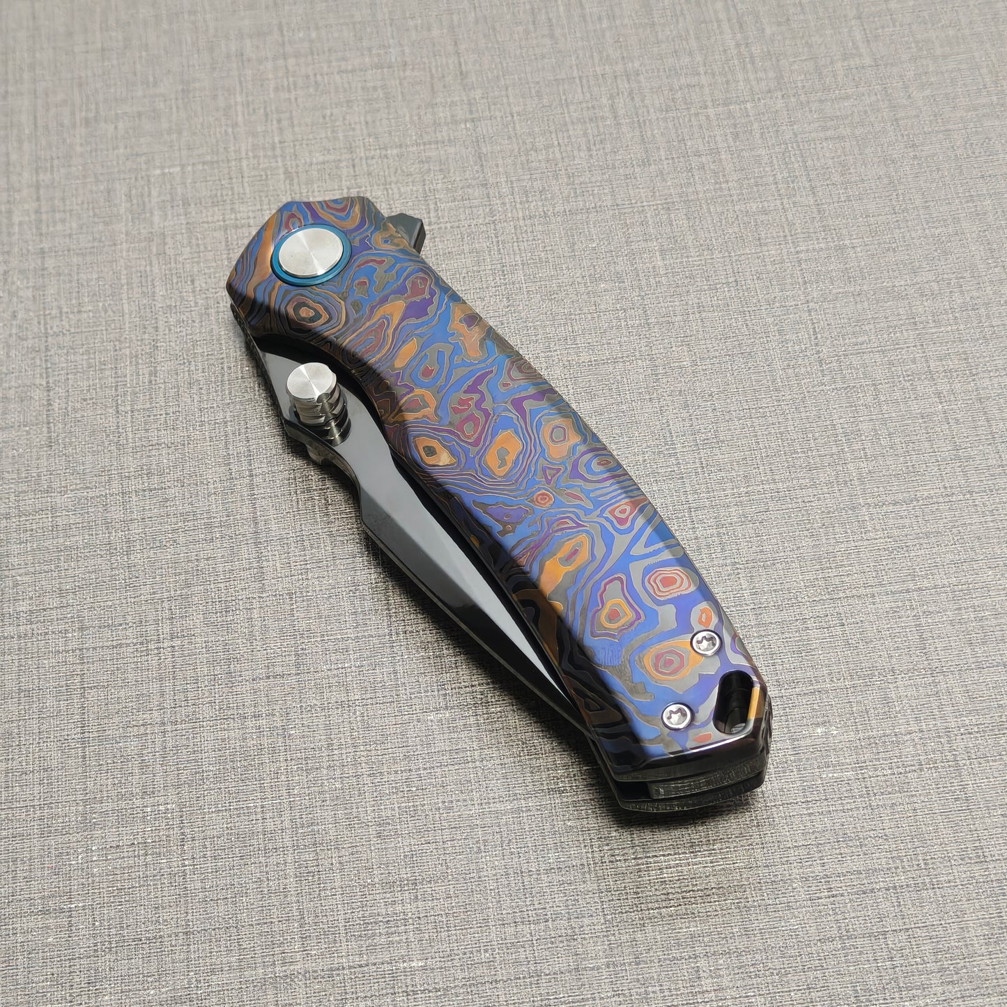 VORIXN Topograph folding knife closed, non-clip side highlighting zirconium handle pattern