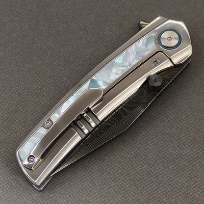VORIXN Ocean Mirage KB104 Folding Knife – closed clip side view with pocket clip and Mother-of-Pearl Inlaid Titanium handle back