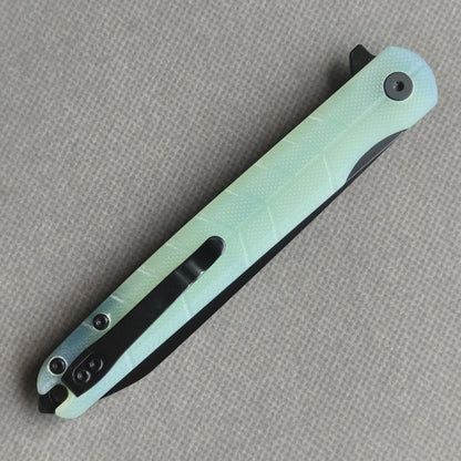 VORIXN KM004 closed clip-side view with pocket clip, screws, and carbon fiber handle back.