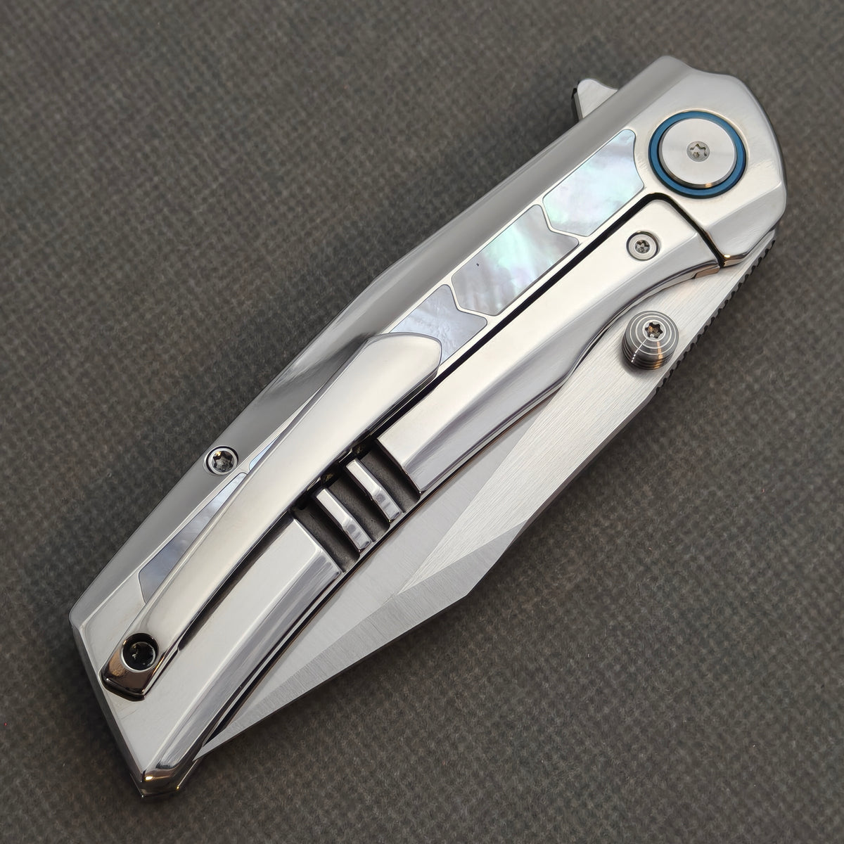 VORIXN Pearlglint KB159 folding knife, closed pocket clip side showing white handle inlays and a polished silver-tone clip.