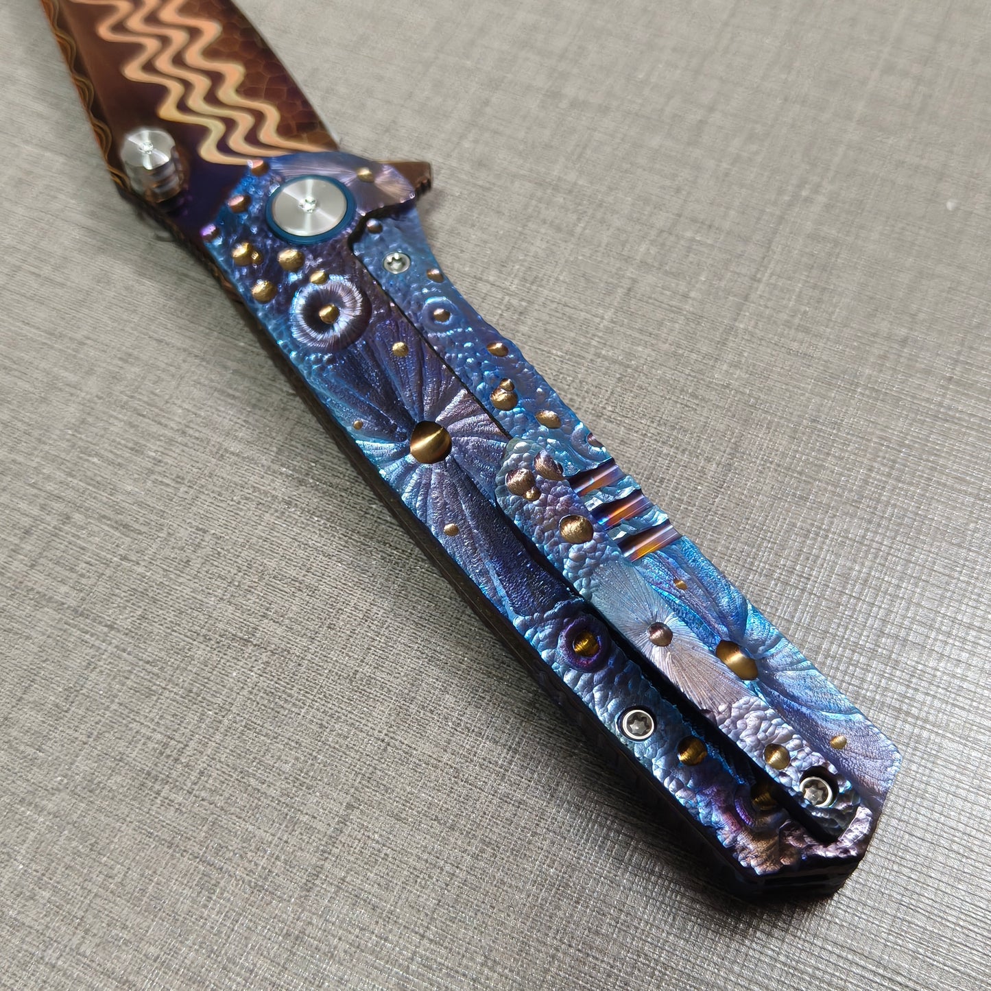 VORIXN Impact Origin folding knife  clip side showing full engraved titanium handle inspired by meteor impacts