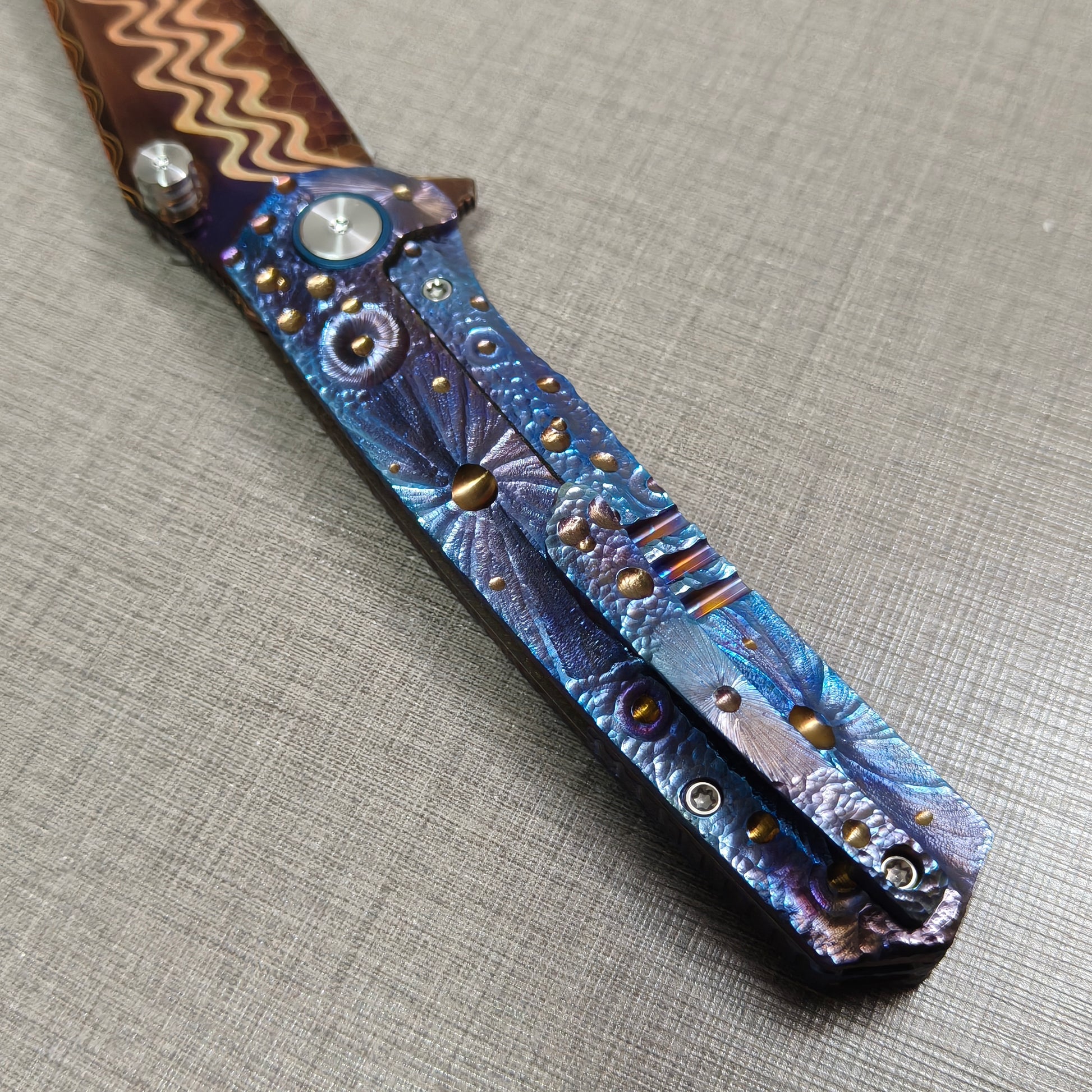 VORIXN Impact Origin folding knife  clip side showing full engraved titanium handle inspired by meteor impacts