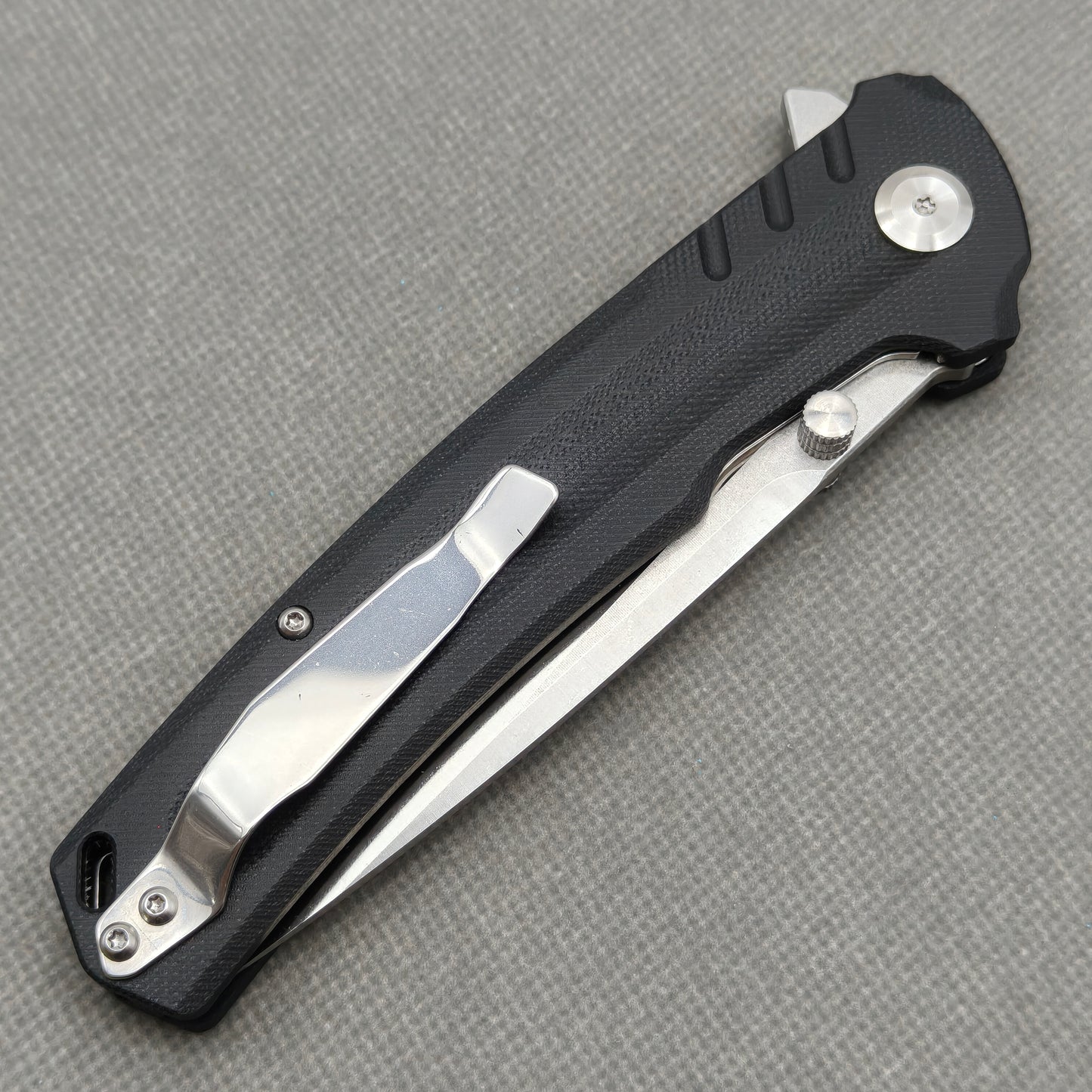 VORIXN KA001 closed clip-side view with pocket clip, screws, and G10 handle back.