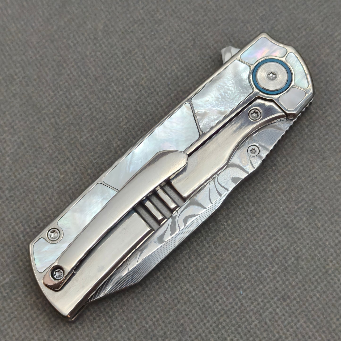 VORIXN KB063 closed clip-side view with pocket clip, screws, and pearl inlaid titanium handle back.