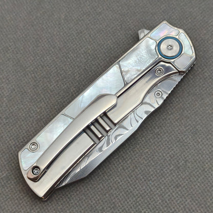 VORIXN KB063 closed clip-side view with pocket clip, screws, and pearl inlaid titanium handle back.