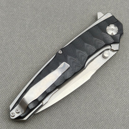 VORIXN KA009 closed clip-side view with pocket clip, screws, and black G10 handle back.