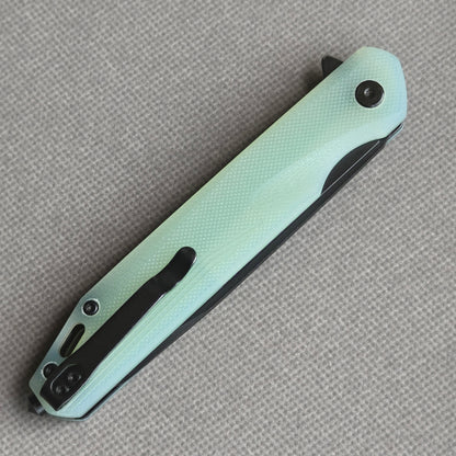 VORIXN KM005 closed clip-side view with pocket clip, screws, and carbon fiber handle back.