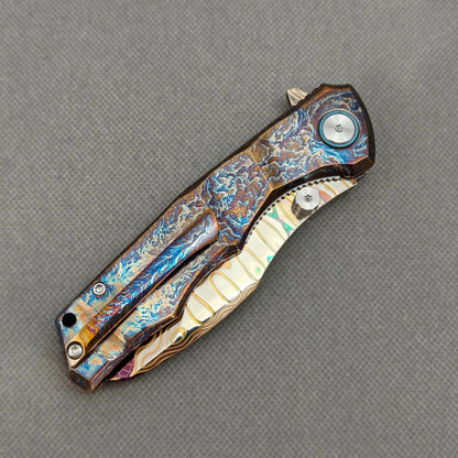 VORIXN KB057 closed clip-side view with pocket clip, screws, and flamed titanium handle back.