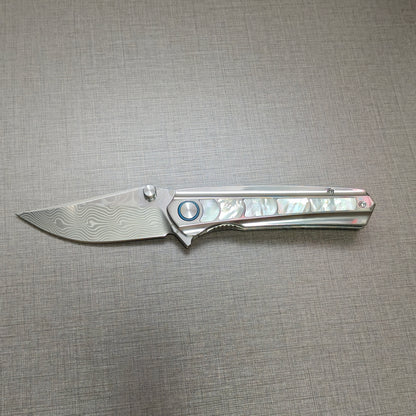 VORIXN Ocean Mirage folding knife open, non-clip side, Damascus blade in horizontal position