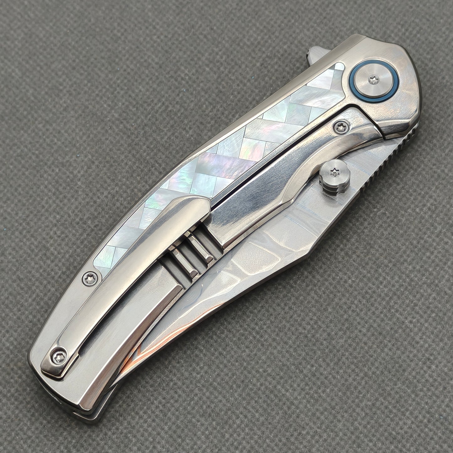 VORIXN KB068 closed clip-side view with pocket clip, screws, and pearl inlaid titanium handle back.