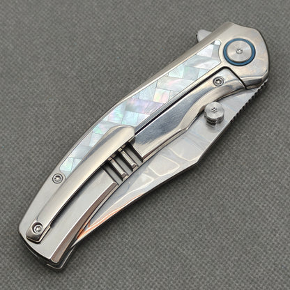 VORIXN KB068 closed clip-side view with pocket clip, screws, and pearl inlaid titanium handle back.