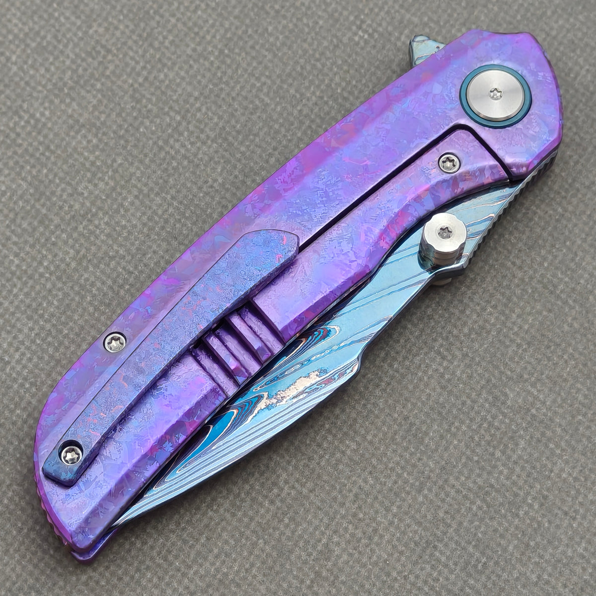 VORIXN Rimeforge KB125 Folding Knife – closed clip side view showing pocket clip and crystallized titanium handle back.