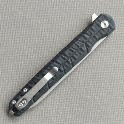 VORIXN KM001 closed clip-side view with pocket clip, screws, and carbon fiber handle back.