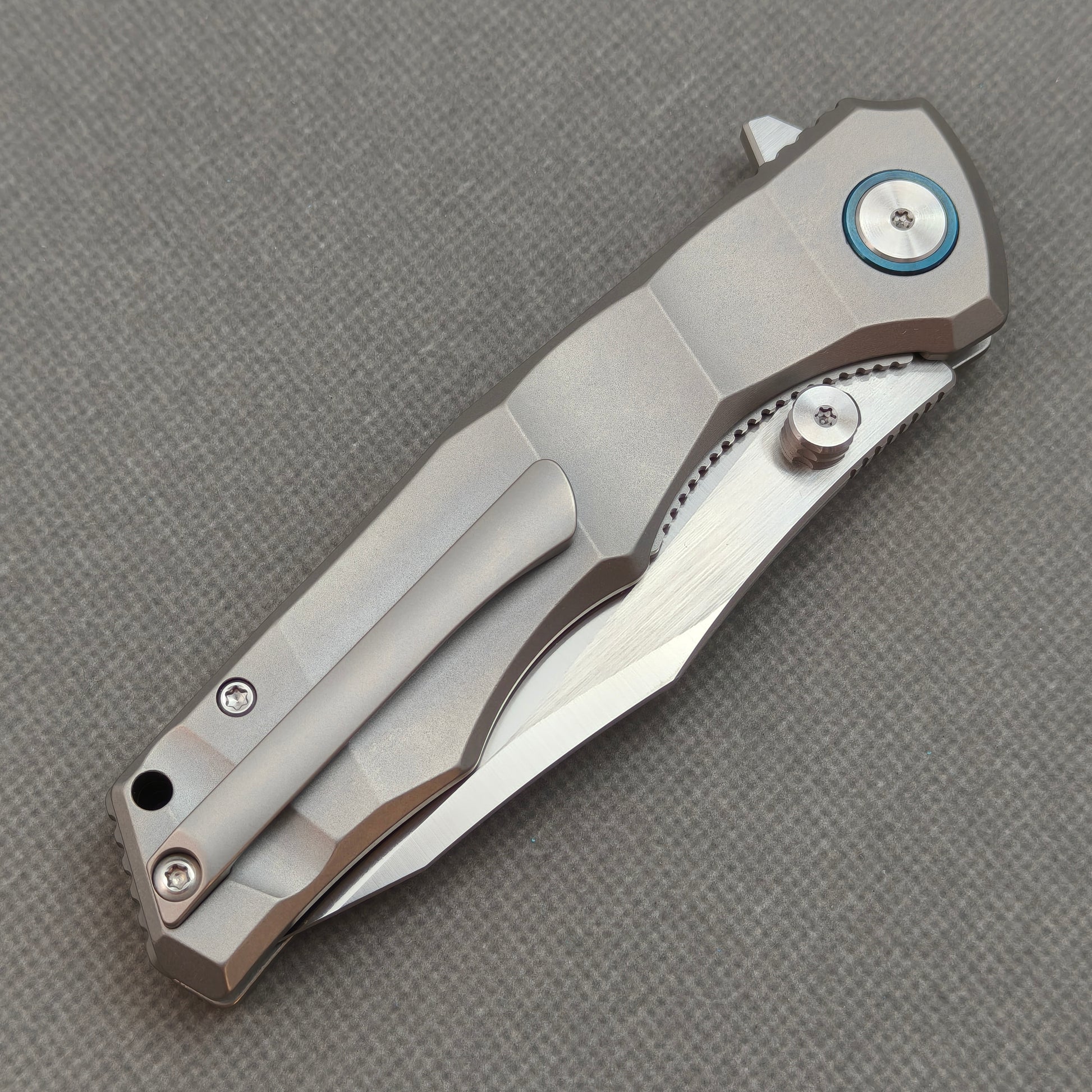 VORIXN KB014 closed clip-side view with pocket clip, screws, and metallic gray titanium handle.