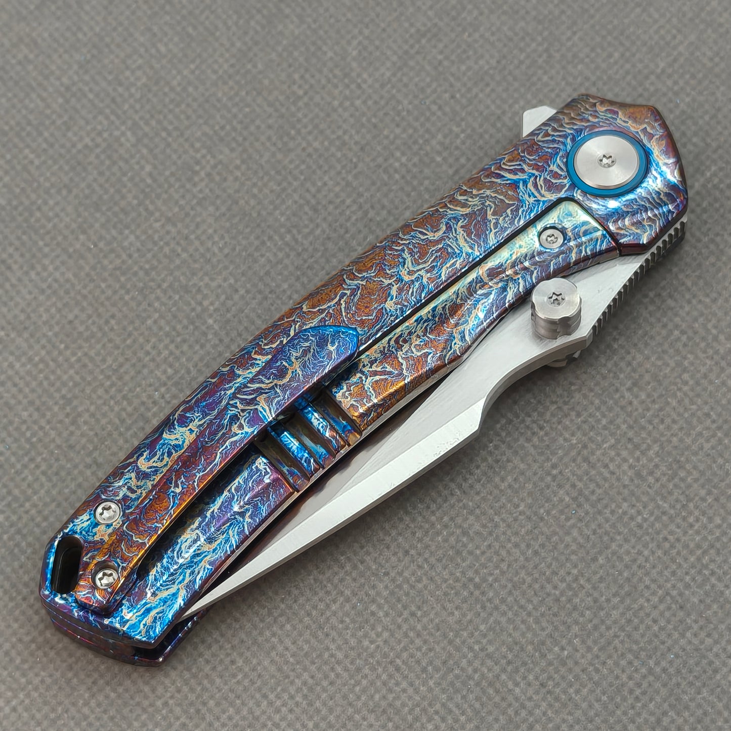 VORIXN KB051 closed clip-side view with pocket clip, screws, and flamed titanium handle back.