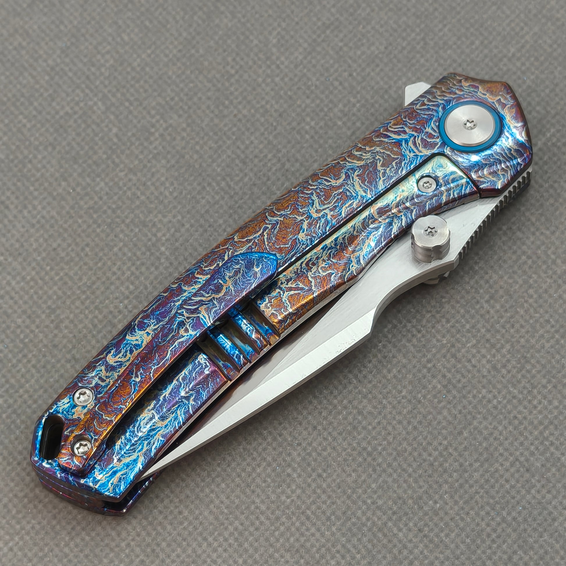 VORIXN KB051 closed clip-side view with pocket clip, screws, and flamed titanium handle back.