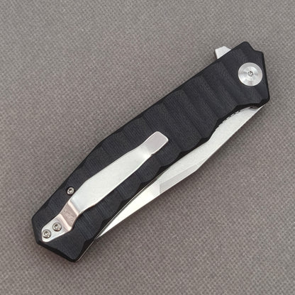 VORIXN KA002 closed clip-side view with pocket clip, screws, and G10 handle back.