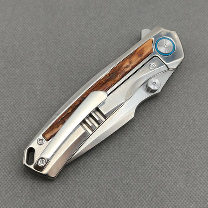 VORIXN KB043 closed clip-side view with pocket clip, screws, and stag inlay handle back.