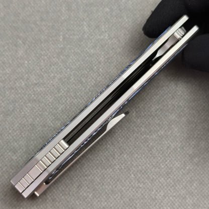 VORIXN Carbon Crest KB003 Folding Knife – closed side construction view showing pocket clip, spacer, and handle layers