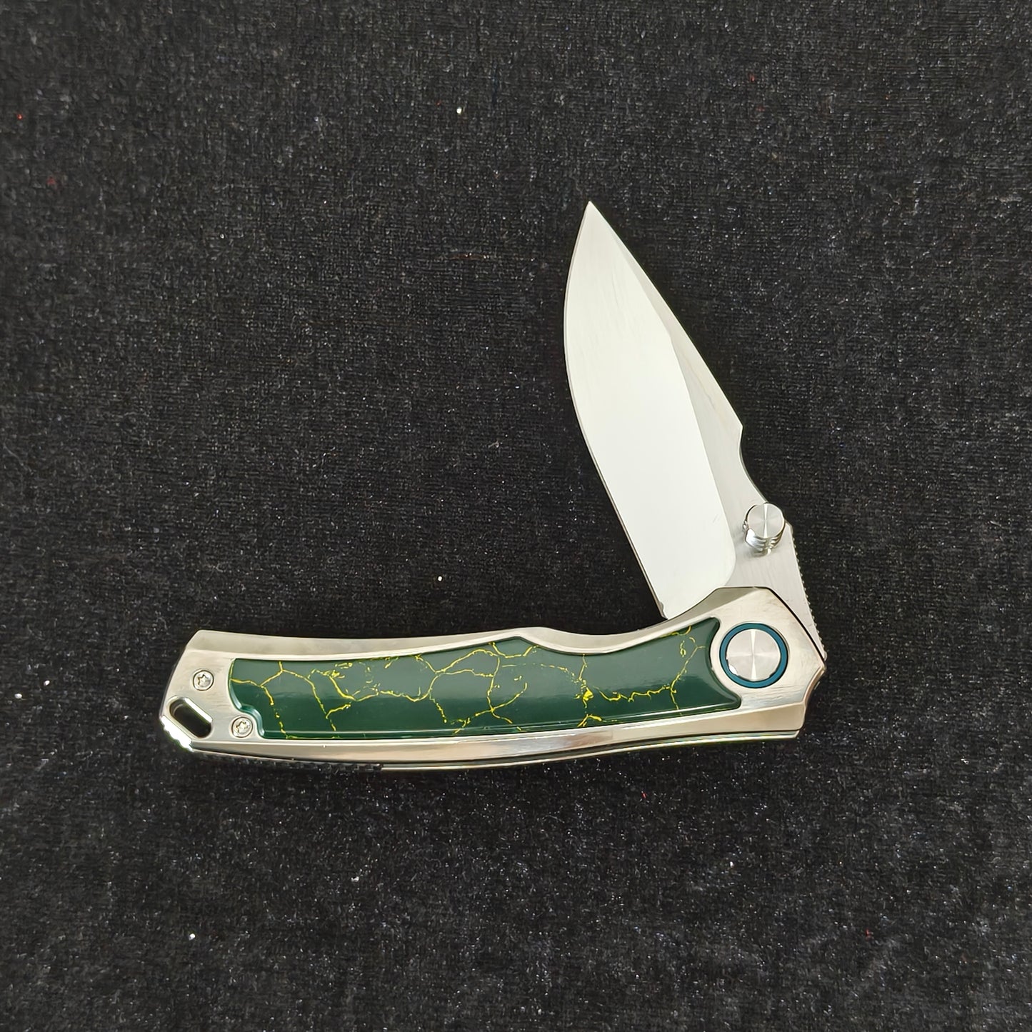 VORIXN Verdant folding knife partially open showing titanium handle profile