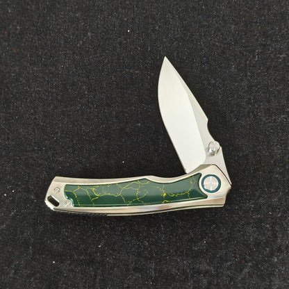 VORIXN Verdant folding knife partially open showing titanium handle profile
