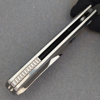 Underside view of the closed VORIXN Ocean Mirage KB093 showing the handle gap, ridged spacer and pocket clip.