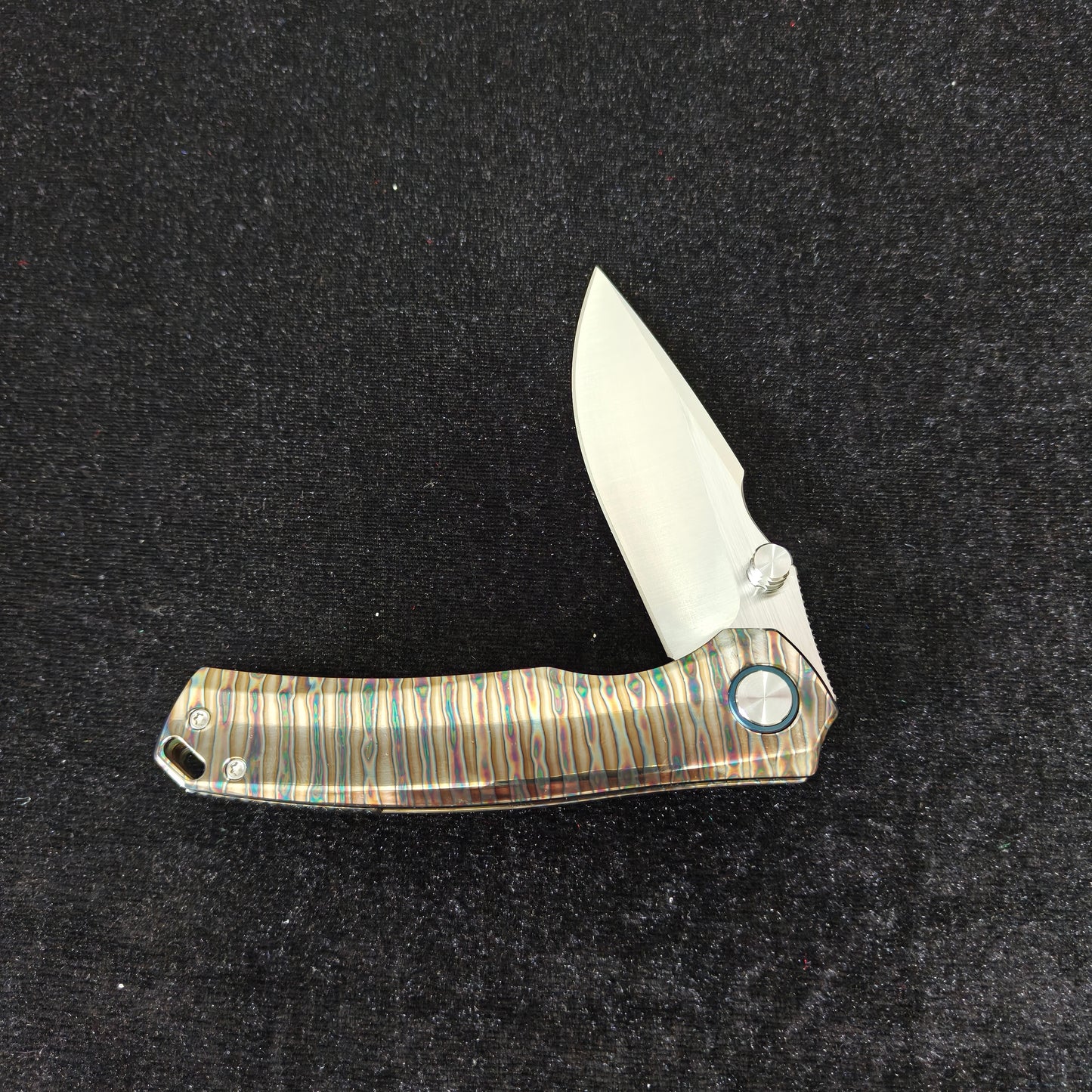 VORIXN Verdant folding knife partially open showing titanium handle profile
